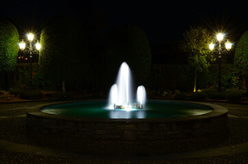 Beautiful and Elegant Water Fountain and Illuminated Street Lamps at Night in Switzerland.