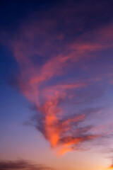 Stunning dramatic sunset sky background with orange purple clouds and pink and red firmament texture
