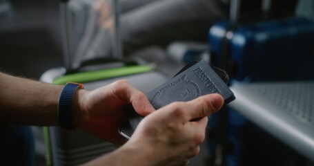 International Airport Terminal: Close Up of Man with Suitcase Sitting in Boarding Lounge of Airline...