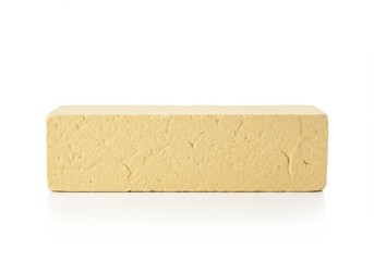Block of firm tofu on a white background, isolated and ready for cooking