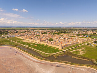 Aigues-Mortes, Camargue, France, medieval city with its surrounding walls, the Constance Tower, typical southern french houses and the salt marshes