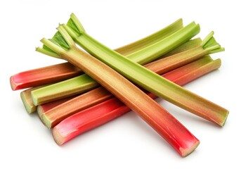 A small pile of fresh rhubarb stalks with green leaves and red stems lie on a white surface in a studio shot