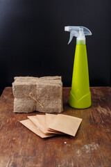 Microgreen growing kit. Paper packages with seeds mockup, water sprayer, hydroponic linen substrate mats on wooden background