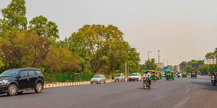 Big traffic Tuk Tuks buses people New-Delhi Delhi India. - Powered by Adobe