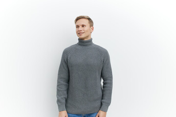 Fototapeta premium smiling man in gray knitted turtleneck sweater standing look aside isolated white background casual autumn winter clothing, mental health concept