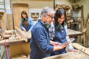 Teamwork in a busy lumberyard with ongoing apprenticeship