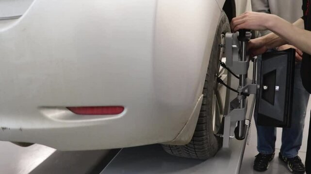 Car wheel diagnostics. installation of special equipment on the wheel close-up.