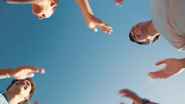 Outdoor, friends and high five with hands for fitness, support and solidarity for training by blue sky. Below, people and smile with applause for motivation, celebrate and synergy for exercise goal