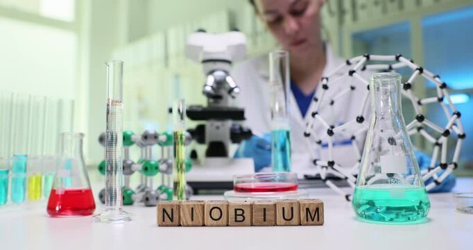 A focused scientist conducts essential research in a lab using niobium and advanced scientific tools