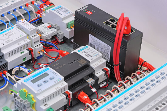 Ethernet EKF data switch with color connected patchcords with Rj45 connectors. Installed in the electrical control panel on the metal board of the DKC panel. 
