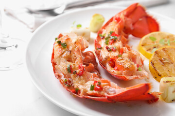Delicious lobster tails with green onion on white table, closeup