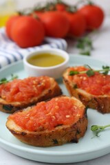 Tasty bread with tomatoes, microgreens and oil on table, closeup