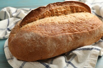 Fresh loaf of bread on table, closeup