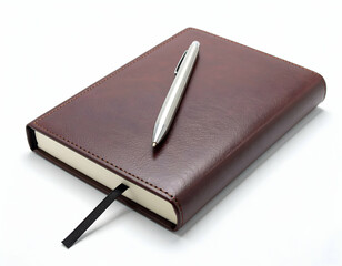 Brown notebook with pen on a brown leather surface