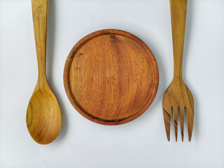 spoon and fork made of wood on a white background