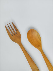 spoon and fork made of wood on a white background