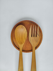 spoon and fork made of wood on a white background