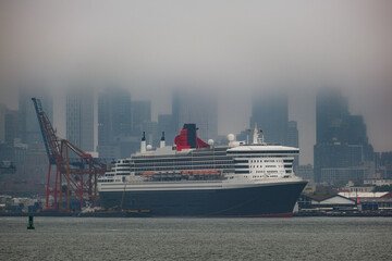 Luxury ocean liner cruiseship cruise ship Queen Mary docked at terminal in Brooklyn on grey rainy...