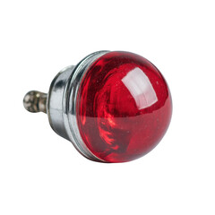 A small, round, vintage red indicator light encased in polished chrome metal is isolated against a stark white background, showing its detail and construction.