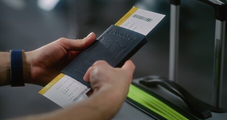International Airport Terminal: Close Up of Man with Suitcase Holding Passport and Plane Ticket,...