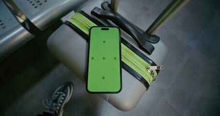 Crowded International Airport Terminal: Mobile Phone with Green Chroma Key Display Mock Up Lying on...