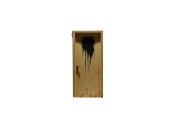 A wooden door with a large, irregular black splatter near the top center, dripping downward.
