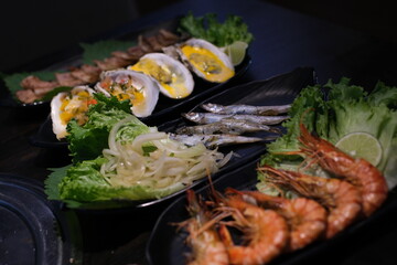 Gourmet Assorted Seafood Platter With Mussels, Salmon, Shrimp, and Octopus on Elegant Tableware. High quality photo