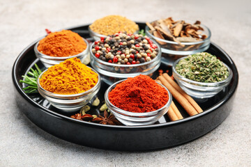 Different aromatic spices on light grey table, closeup