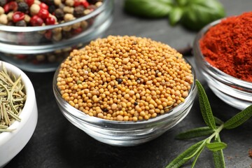 Different aromatic spices on black table, closeup