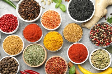 Different aromatic spices on grey table, flat lay