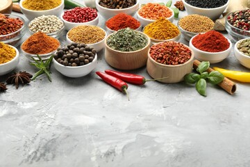 Different aromatic spices on grey table, closeup. Space for text