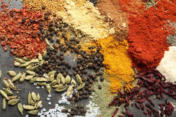 Many different spices on dark table, flat lay