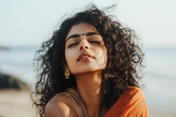 Relaxed Indian Woman with Curly Hair Enjoying the Beach