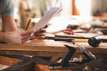 Young carpenter working in his workshop