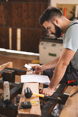 Young carpenter working in his workshop