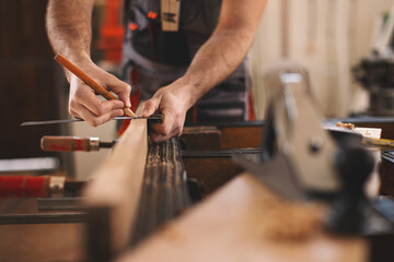 Young carpenter working in his workshop