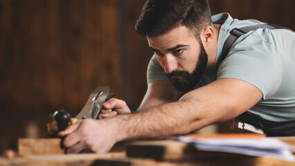 Young carpenter working in his workshop