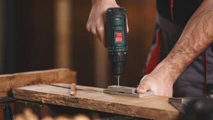 Young carpenter working in his workshop