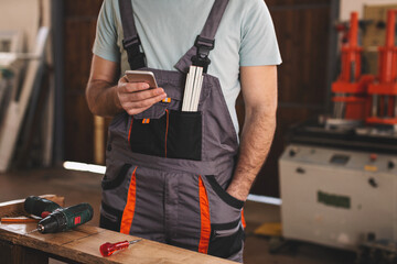 Young carpenter working in his workshop