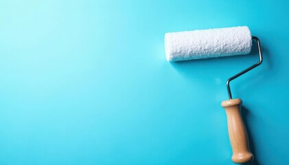 Obraz premium White paint roller on blue wall background Copy space , blue wall, image, graphic