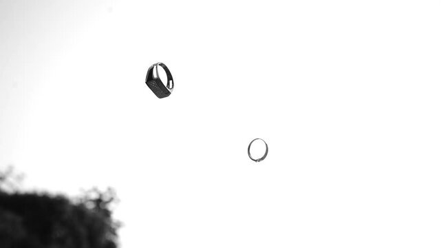 A timeless black-and-white slow-motion shot captures the couple's rings flying gracefully through the air. Suspended between two hearts, the rings symbolize eternal love, floating in perfect harmony b