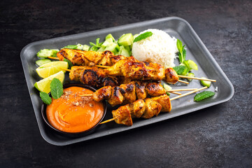 Sate Ayam- Grilled chicken satay sate skewers with peanut dipping spicy sauce, steamed rice and...