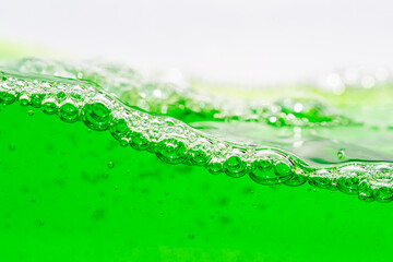 Water wave, close up of vibrant green liquid with bubbles, capturing dynamic movement and...