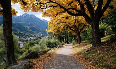 Scenic path lined with trees in vibrant autumn colors. Mountain range visible in background