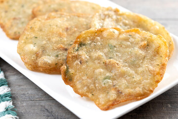 Tortillitas de camarones on wooden table. Traditional spanish food. Close up