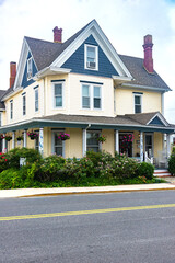 Beautiful single family home by the road. Shrubs, flowers and lawns decorate the exterior of the house.