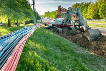 Naklejka na ściany i meble excavator and drilling equipment for laying broadband internet cables underground.