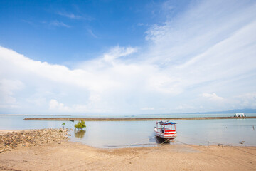 The beauty and comfort of the tropical beach of Lasiana Beach in Kupang City, East Nusa Tenggara, Indonesia with traditional boats moored. This beach is a favorite tourist destination in Kupang.