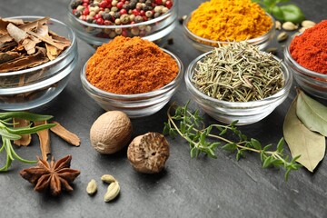 Different aromatic spices on grey table, closeup