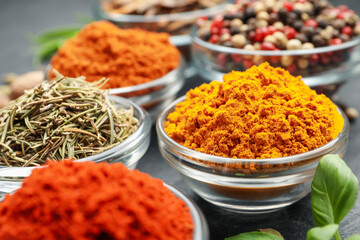 Different aromatic spices on grey table, closeup